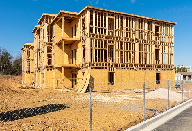 a close-up of temporary chain link fences enclosing a construction site, signaling progress in the project's development in West Homestead